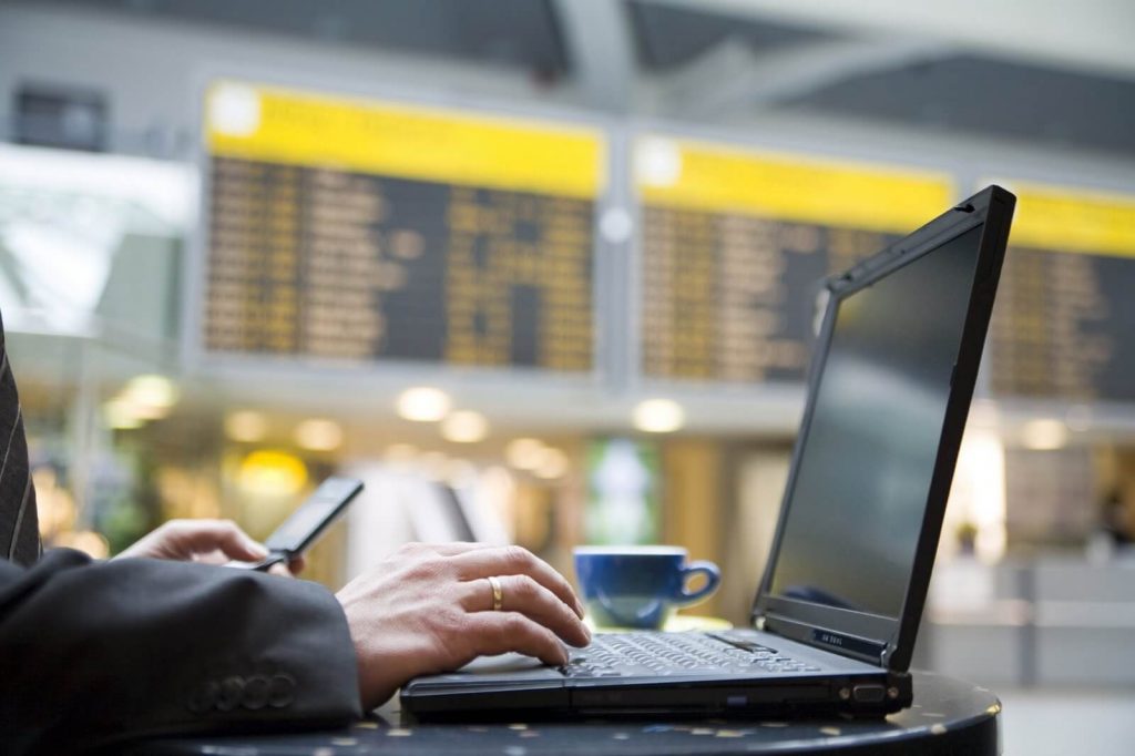 executivo usando notebook para ilustrar texto sobre gastos com viagens
